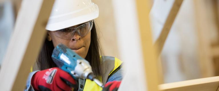 Woman working on wood at Skills Strategy Construction Academy launch event