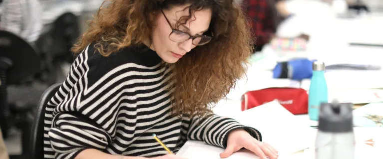 Woman writing at a desk