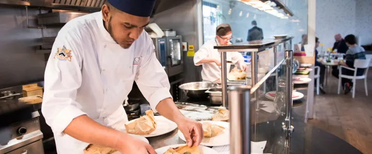 Young man preparing food in a professional kitchen