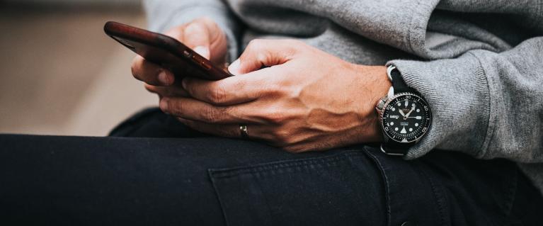 Person browsing on mobile phone