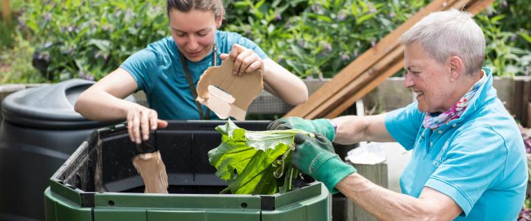 Two people recycling food