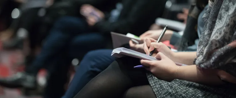 Journalists taking notes at conference