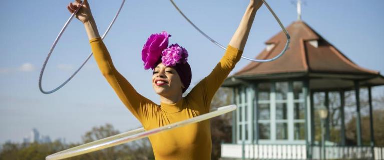 A person hula hooping with four hula hoops