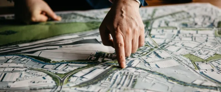 OPDC map a person hand is pointing on the map