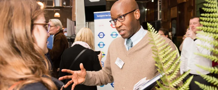 Two people talking at community event