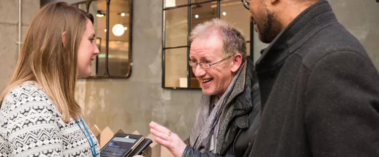 Three people talking at consultation event