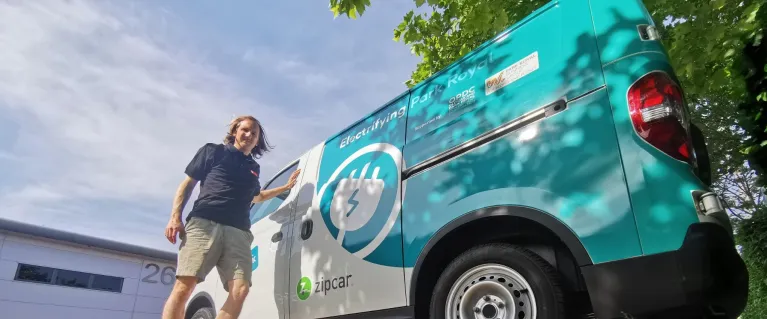 Man standing next to Zip van
