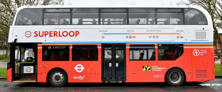 A double decker London bus with the superloop roundel on the side and the word Superloop in large red letters