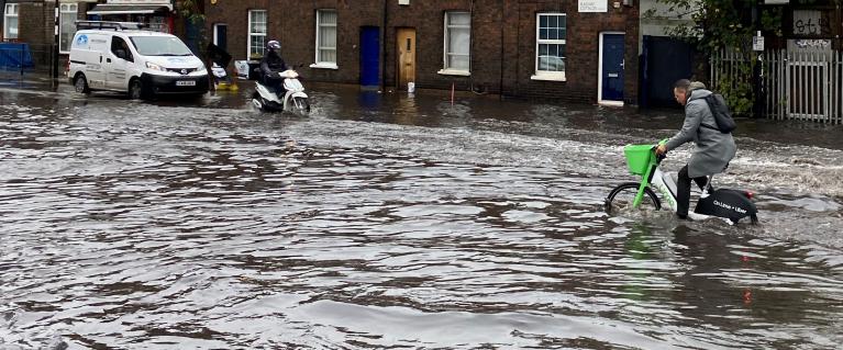 Bike going through surface water on London road