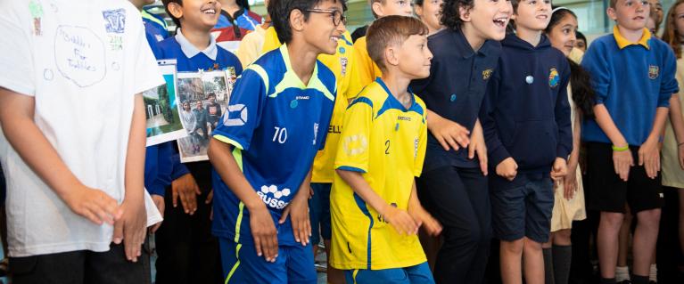 Young children standing and cheering