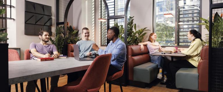 Social area inside London Hayloft Point showing groups of students interacting