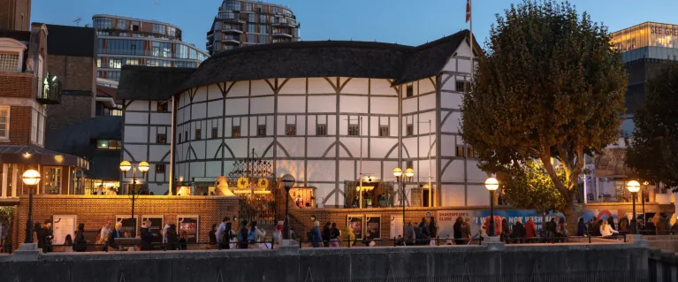 The outside of the globe theatre in London at night
