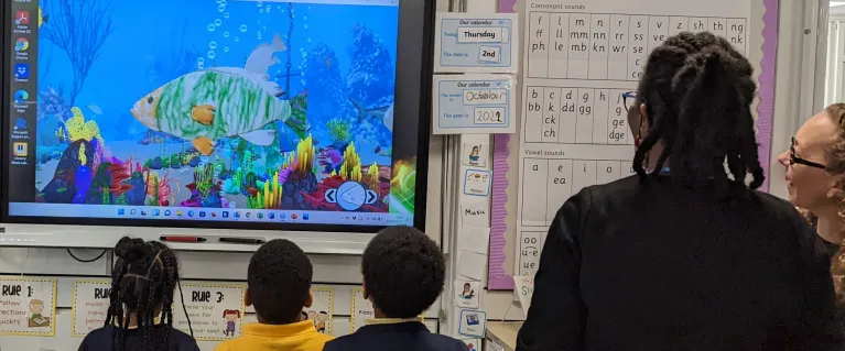 Children watch sea creatures in virtual aquarium