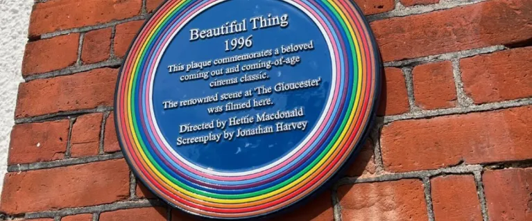 A rainbow plaque on a wall in London 