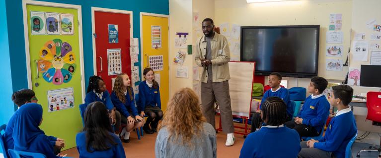 Teacher in a classroom with school children