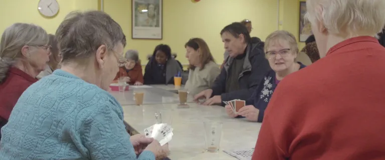 Community members playing a card game at The Abbey Centre