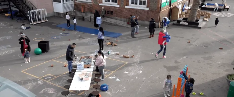 Children and parents playing together at Surrey Square Primary School playground