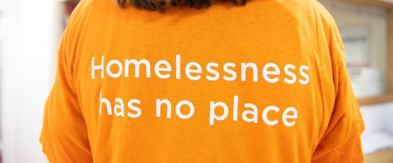 Back of a t-shirt that says Homelessness has no place
