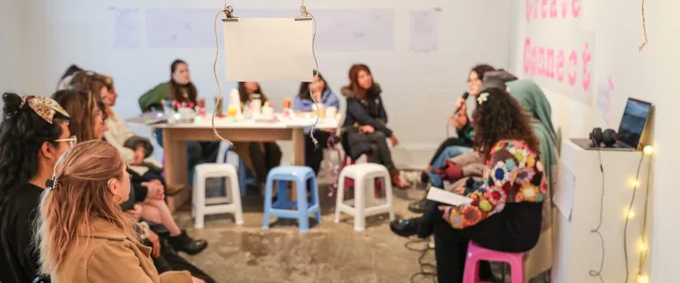 People sitting during an artist panel at an exhibition opening evening