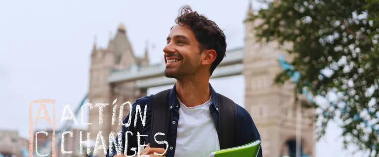 A man smiling outside in London with the text 'ACT, Action Changes Things'