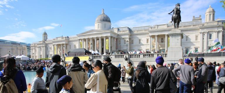 people standing and walking in Trafalgar Square