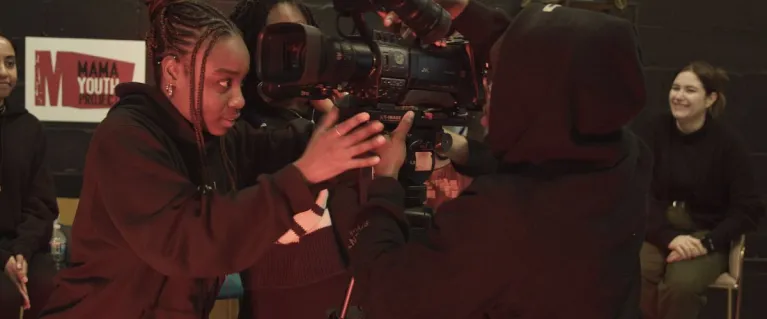 young people using a TV camera