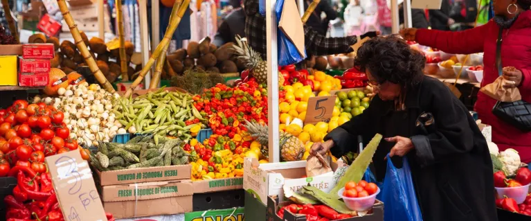 Woman shopping at fruit and veg stall