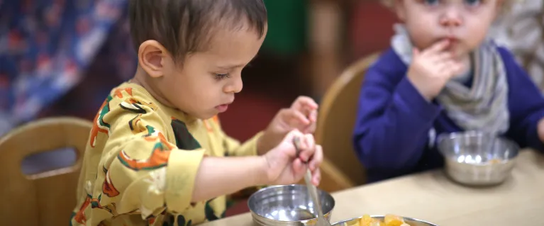 Young children eating oranges