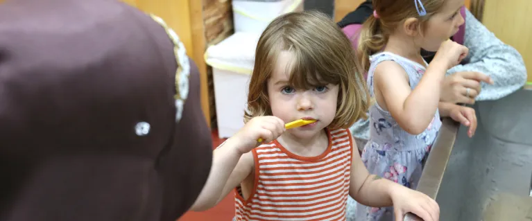 Children brushing their teeth as part of a supervised toothbrushing programme