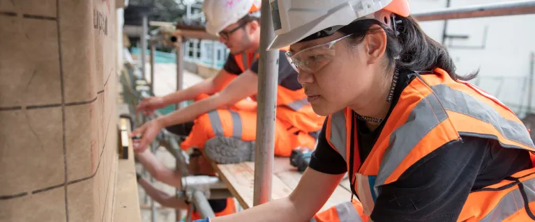 construction worker fitting wood