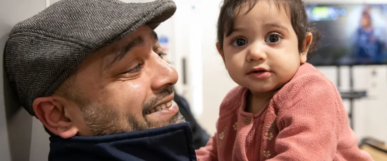 Father and child sitting down.
