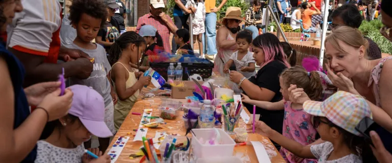 Children making crafts at a table outdoors, photo by Dave Reeve