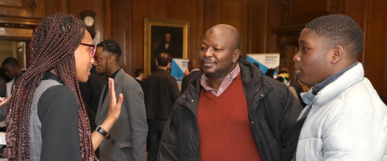 Two men asking for information at event