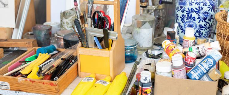 Table full of paint and art materials at Gnome House community arts centre Walthamstow