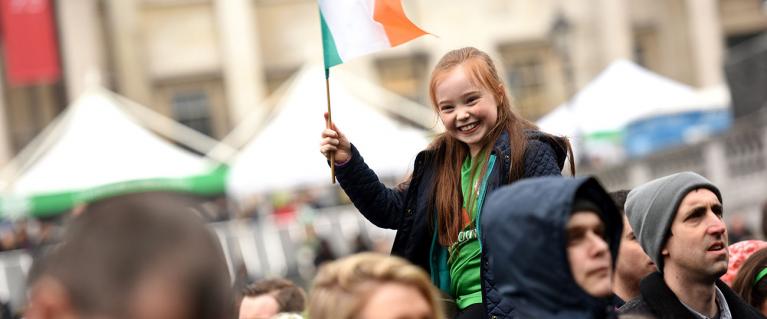 Girl holding the Irish flag on St Patrick's Day in Trafalgar Square