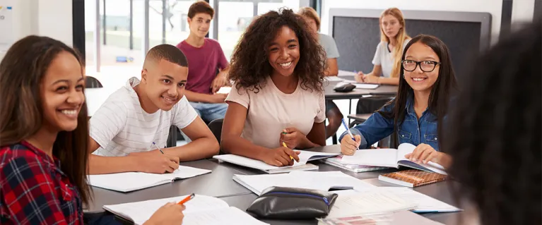 Students around a table in a classroom