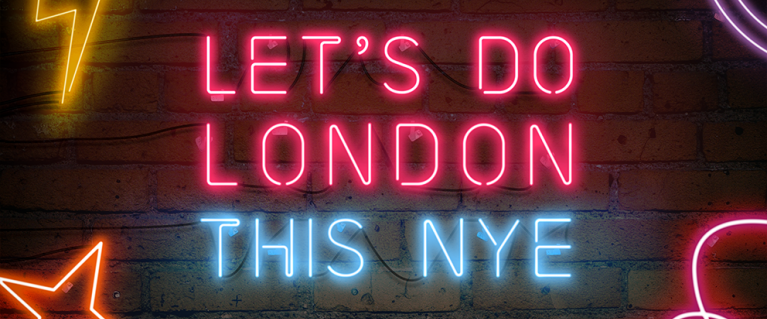 The message 'Let's Do London this NYE' in neon nights on a brick way