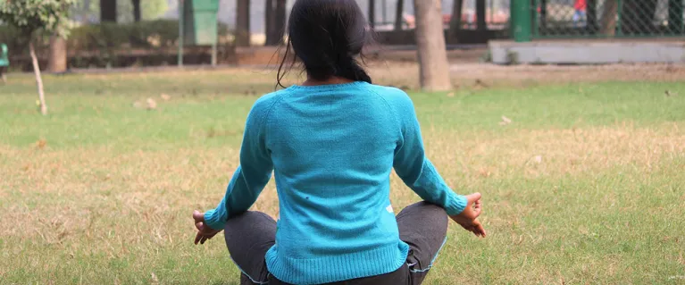 Person doing yoga in a park