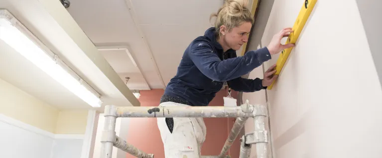 Community led housing of a woman working