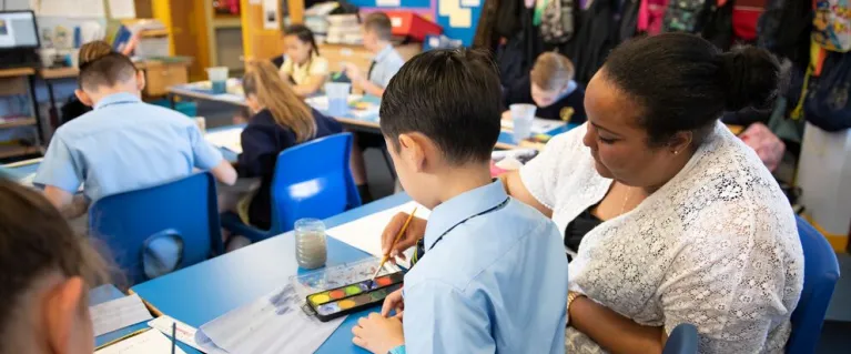Young students in a classroom engaging in arts