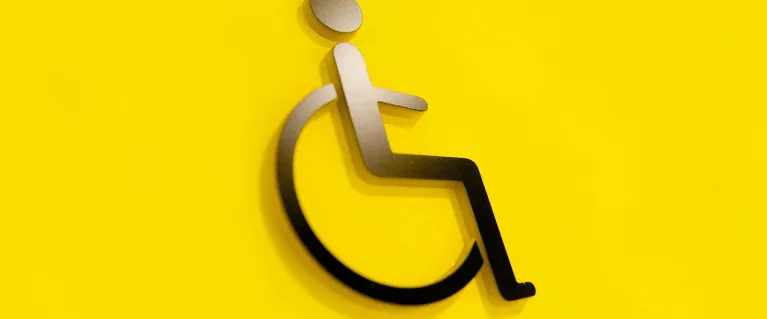 Person on wheelchair icon on yellow background