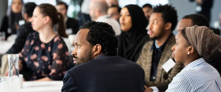 group of people listening to someone out of frame
