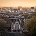A view across London at sunset with a warm orange sky