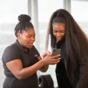Two young women looking at a mobile phone