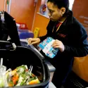 Woman scanning food at a checkout till