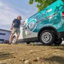 Man standing next to Zip van