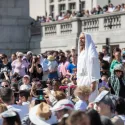 Actor portraying Jesus stands within a crowd on Trafalgar Square