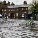 Bike going through surface water on London road