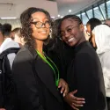 Two young girl hugging and smiling at the camera