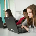Young woman looking at laptop screen.